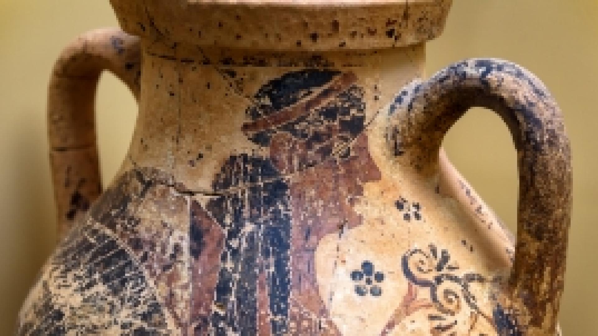 An ancient vase with drawings on it
