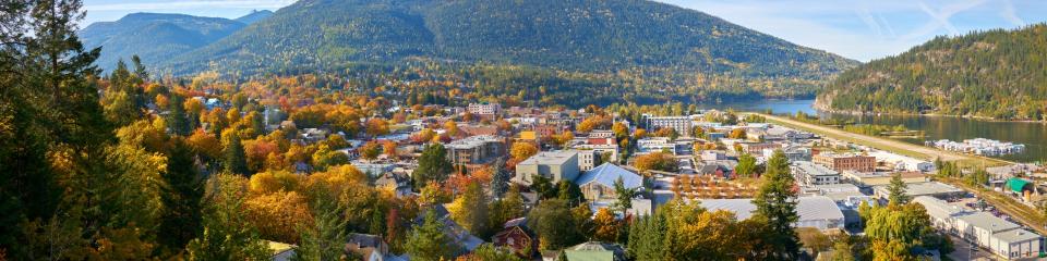 Small town with autumn leaves and mountains